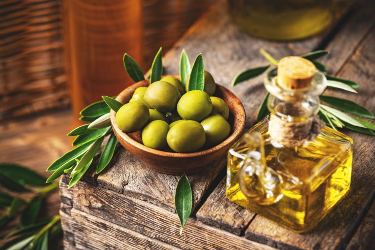Image of olives and olive oil in rustic style, still life
